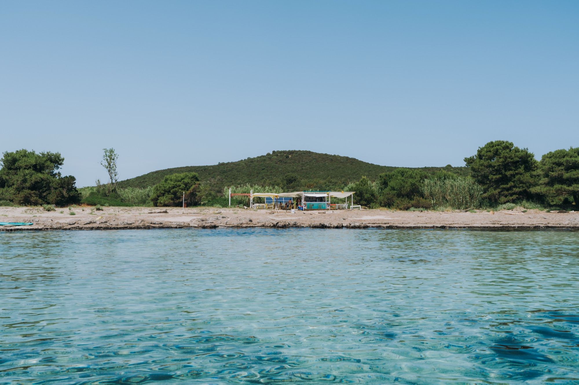 Shallow turquoise water at Ilovik's sandy bay