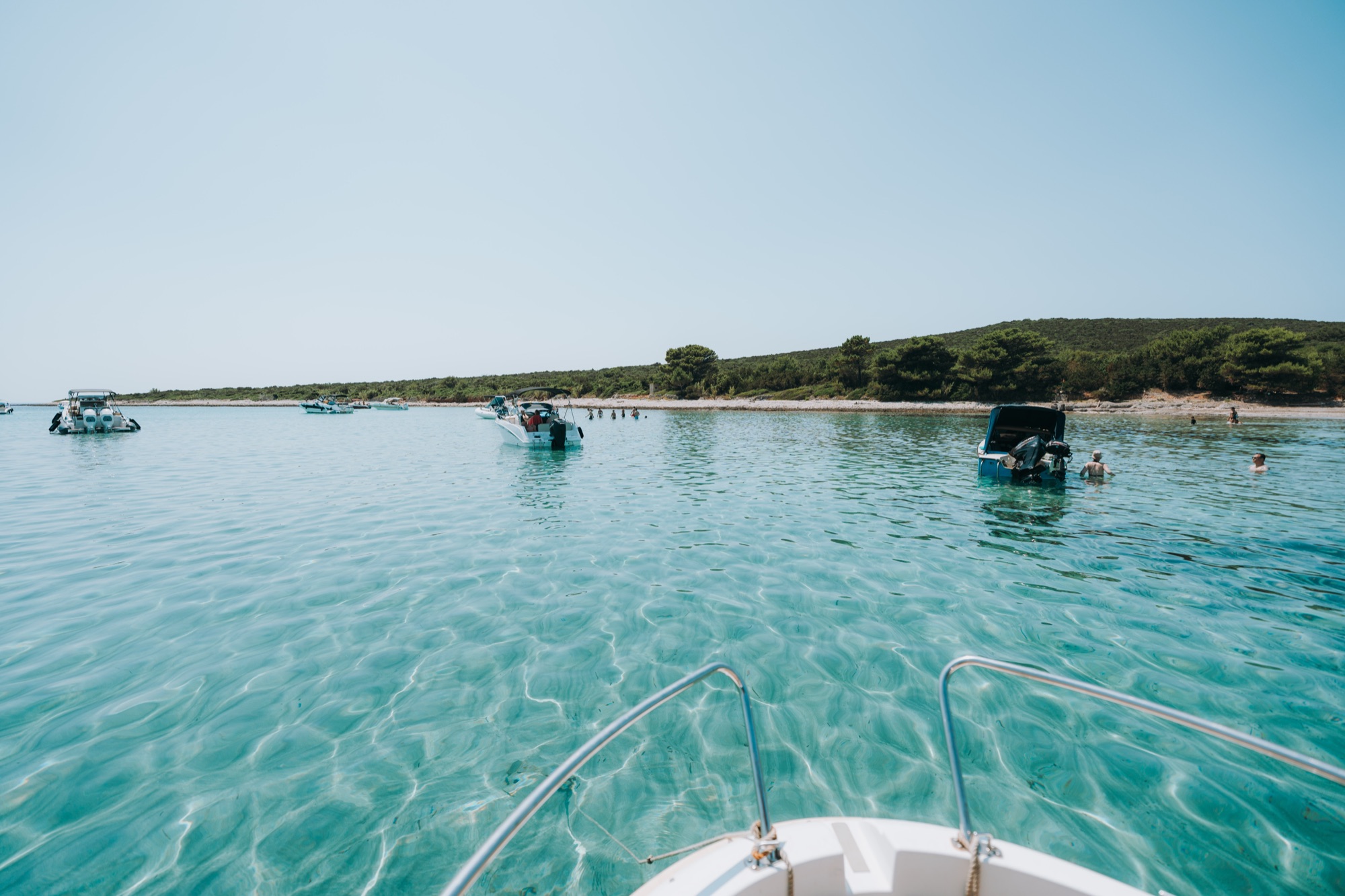 Crystal-clear water with boats off Ilovik