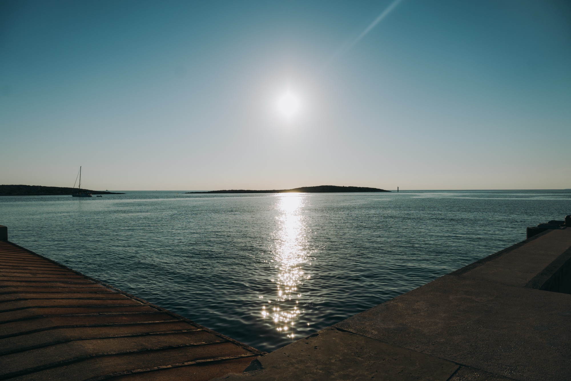 Low evening sun over the water between the piers at Krijal harbour